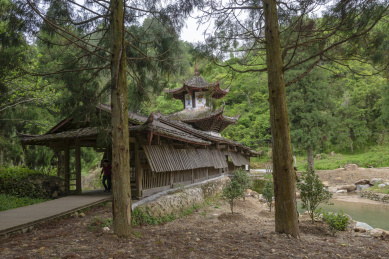掩映在几棵大松树中的一座古老木结构廊桥