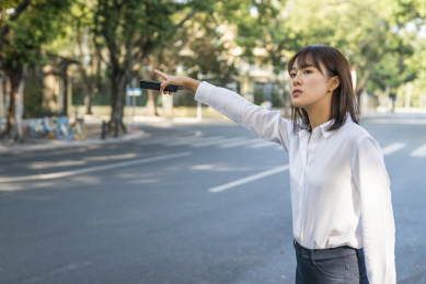 在马路边拦车的商务女白领