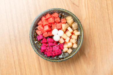 放在木质桌面上的水果圆子冰粉