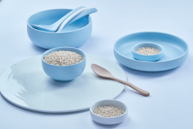 白色背景上的青釉瓷餐具装的燕麦米（莜麦）