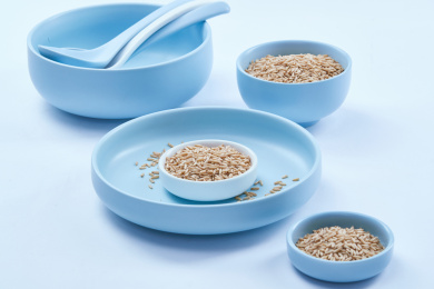 白色背景上的青釉瓷餐具装的燕麦米（莜麦）