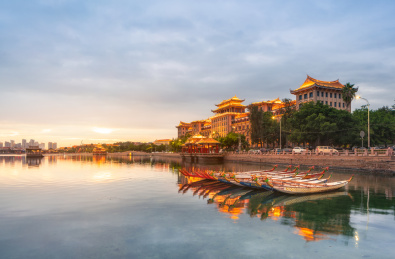 中国福建省厦门市集美学村龙舟池里的龙舟及岸边南侨楼群建筑夜景