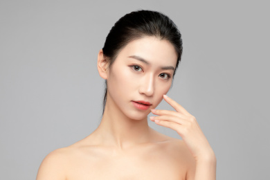灰色背景里的亚洲美女面部特写，化妆护肤整容