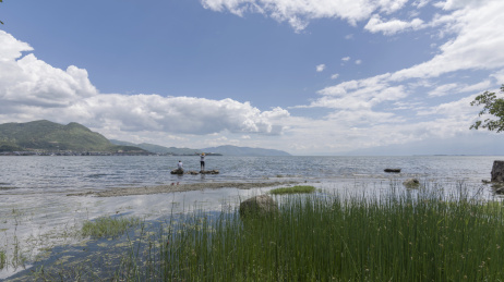 云南大理洱海湖畔水中两个看风景的人物背影