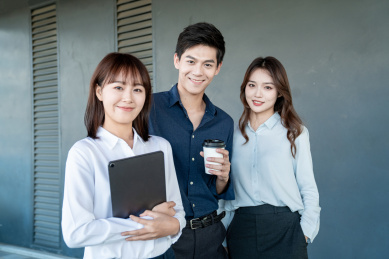 三个年轻的商务人士在室内站在一起