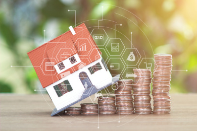 上涨的美元硬币和小房子模型组成的房地产投资概念