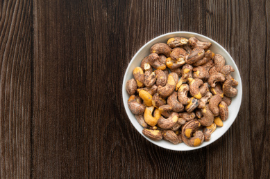 放在木纹背景上的一盘红腰果