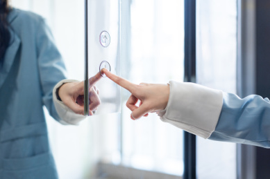 一位商务女士用手指按电梯按键