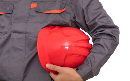 民工手拿红色安全帽在白背景前