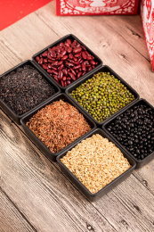 桌子上用方形黑色碗装着的六种豆子杂粮