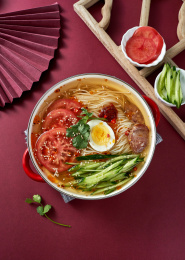 深红色背景上餐具里盛放的朝鲜冷面