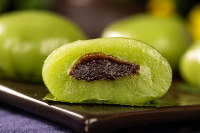 黑色碟子上放着切开的青团