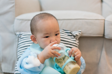 房间里穿着睡衣在吃奶的婴儿