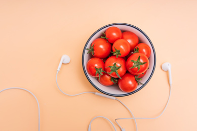 碗里装满圣女果、小番茄与耳机摆放在一起