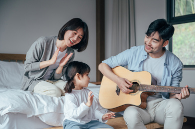 爸爸妈妈和女儿在家唱歌