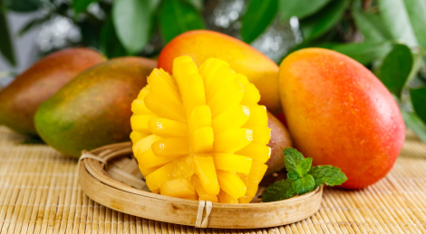  竹垫子上放着一篮贵妃芒和贵妃芒果肉 