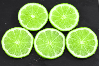 黑底上放着切片的无籽青柠檬