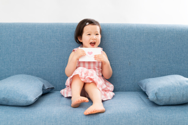 可爱的女孩拿着明信片 