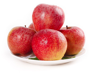 白底上放着一盘秦冠苹果和苹果果肉