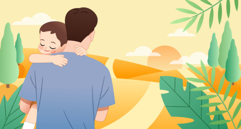 一个父亲抱着孩子走在户外的路上