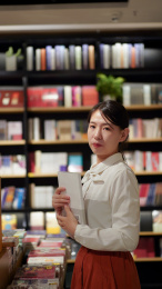 一位年轻女性在图书馆看书