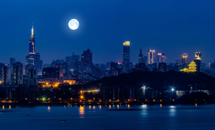 江苏省南京市夜晚月亮光照长江外滩高楼建筑