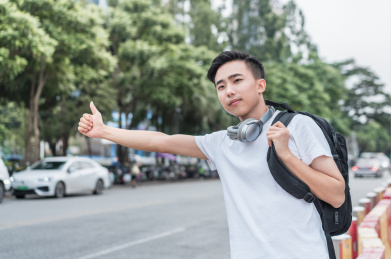 在马路边招手打车的男青年