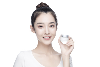 漂亮的亚洲美女抹面霜白色背景半身肖像