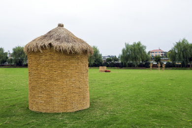 农耕节上摆放在绿草地上的农耕艺术品