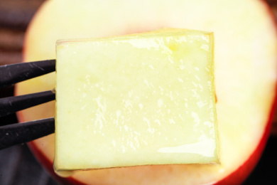 叉子上叉着一块桃子果肉特写