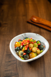 棕色木纹桌上放着一盘巧拌小皮蛋   