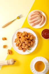 纯色背景上满满一盘油炸鸡米花