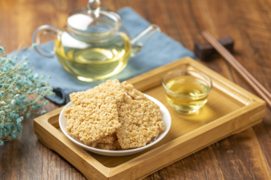 一盘锅巴摆放在木桌面上特写