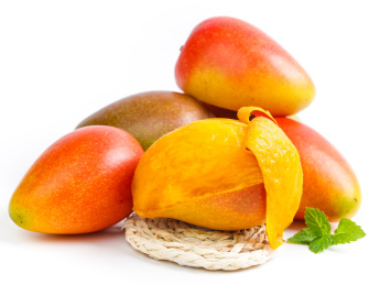 白底上放着金龙果和草垫上放着撕开皮芒果