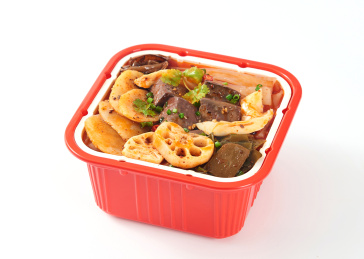 白色背景上摆放的牛油鸭血火腿自热小火锅