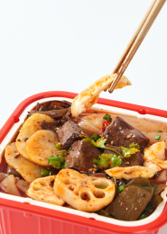 白色背景上摆放的牛油鸭血火腿自热小火锅