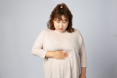 胃疼的亚洲肥胖女孩儿 手捂肚子