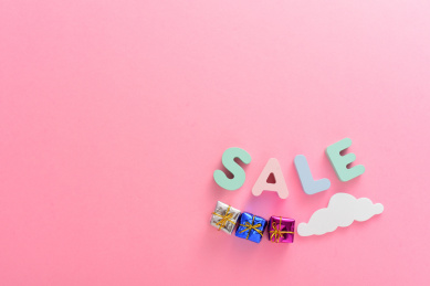 粉色背景上的彩色字母积木SALE