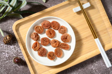 桌面上的白色陶瓷盘子里的美味的日式梅饼