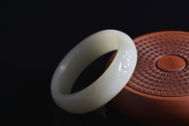 暗色背景上的和田玉雕花手镯