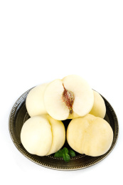 白底上放着一盘新鲜白桃