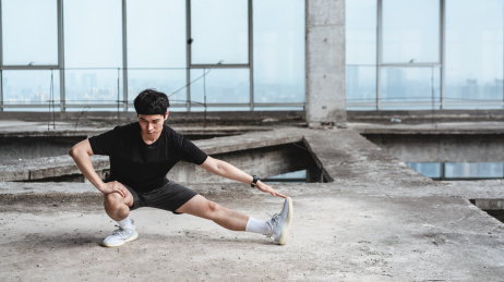 年轻运动男子在做拉伸动作