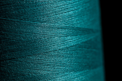 细密交叉的青色缝纫机线特写