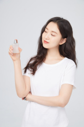 手拿香水的年轻女性