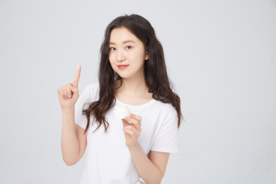 手拿护肤品的年轻女孩