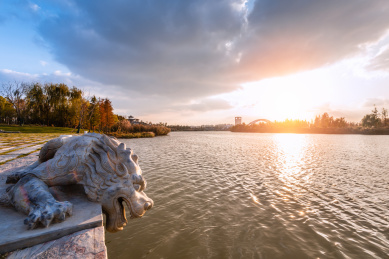秋天夕阳下的扬州运河三湾河岸的石龙石雕趴