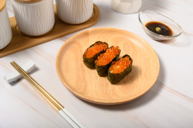 桌面上的盘子里的美味可口的三文鱼子寿司