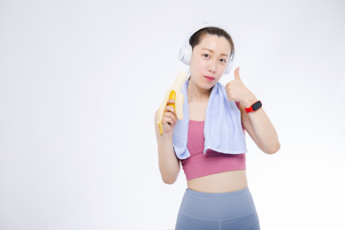 运动前吃香蕉补充能量的女生