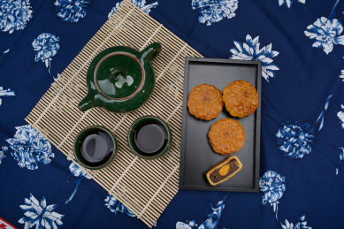 蓝花布上的茶壶茶杯月饼
