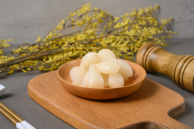 桌面上的盘子里的美味可口的甜酸荞头